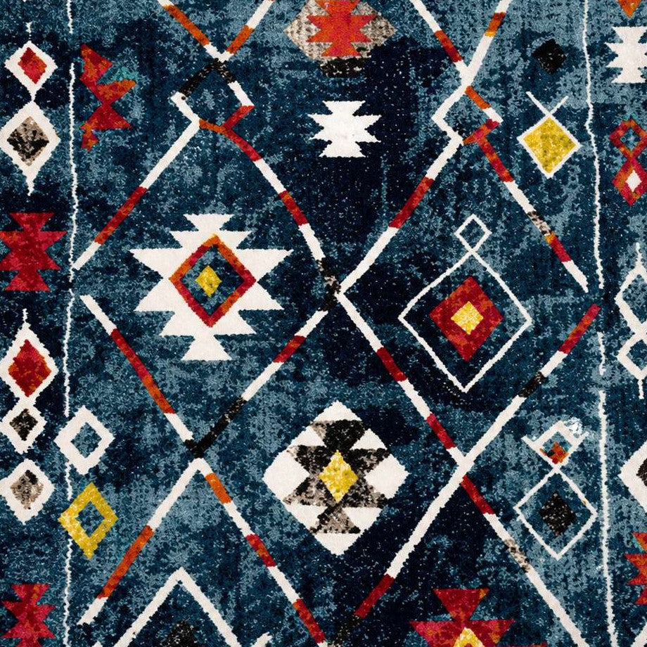 Tapis berbere à motifs géométriques colorés sur fond bleu, style traditionnel marocain